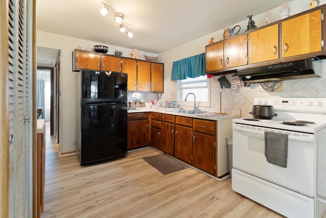 kitchen featuring tasteful backsplash, sink, white electric range oven, black fridge, and light wood-type flooring