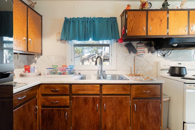 kitchen featuring range hood, sink, backsplash, and white electric stove