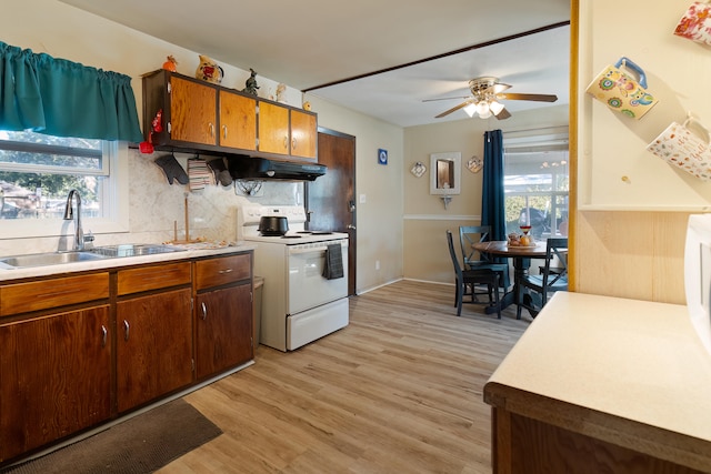 kitchen featuring sink, white electric range, light hardwood / wood-style flooring, ceiling fan, and backsplash