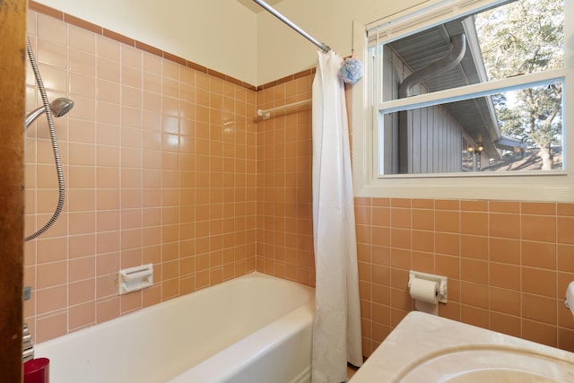 bathroom featuring shower / tub combo with curtain and sink