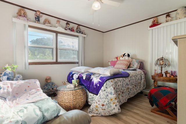 bedroom featuring crown molding, ceiling fan, and light wood-type flooring