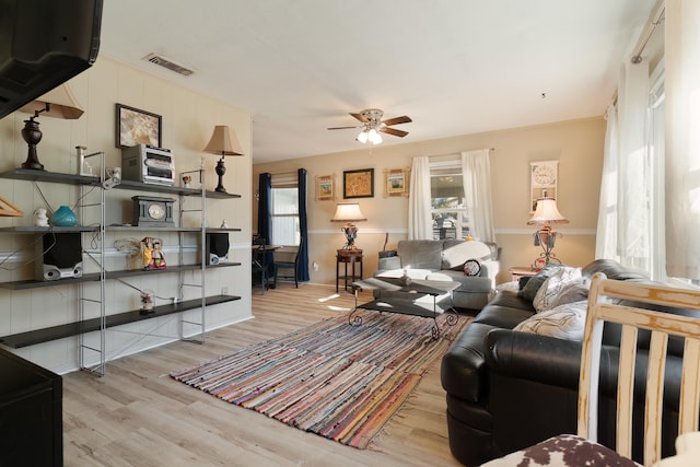 living room with ceiling fan and light hardwood / wood-style floors