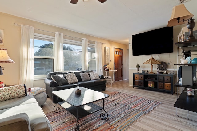 living room featuring hardwood / wood-style floors and ceiling fan