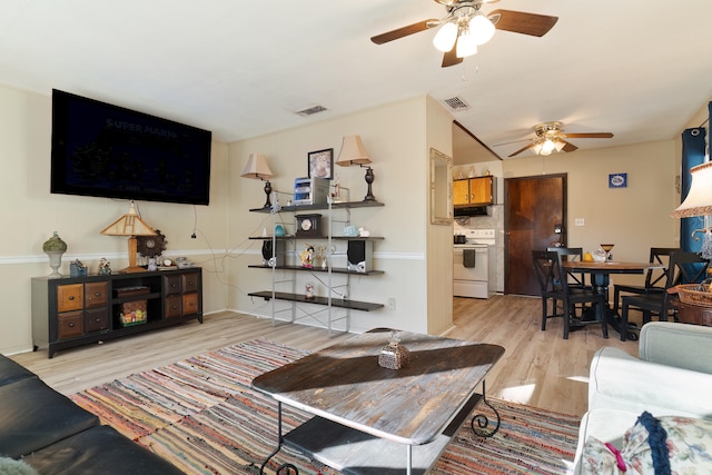 living room featuring ceiling fan and light hardwood / wood-style floors