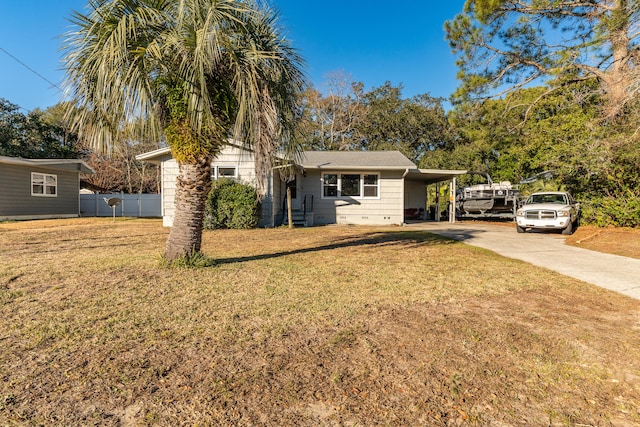 view of front of property with a carport and a front lawn