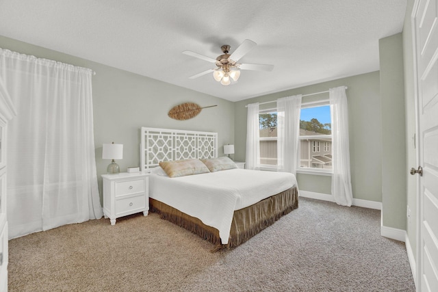 bedroom with light carpet, a textured ceiling, and ceiling fan