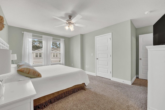 bedroom with carpet, a textured ceiling, and ceiling fan