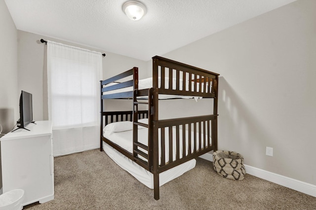 bedroom featuring carpet floors and a textured ceiling