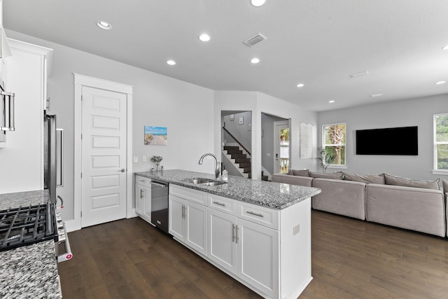 kitchen featuring appliances with stainless steel finishes, dark hardwood / wood-style floors, white cabinetry, sink, and light stone counters