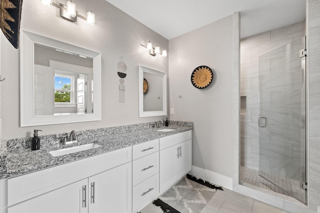 bathroom with tile patterned flooring, vanity, and a shower with shower door