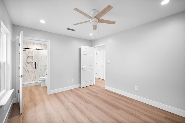 unfurnished bedroom featuring light hardwood / wood-style floors, ceiling fan, and ensuite bathroom