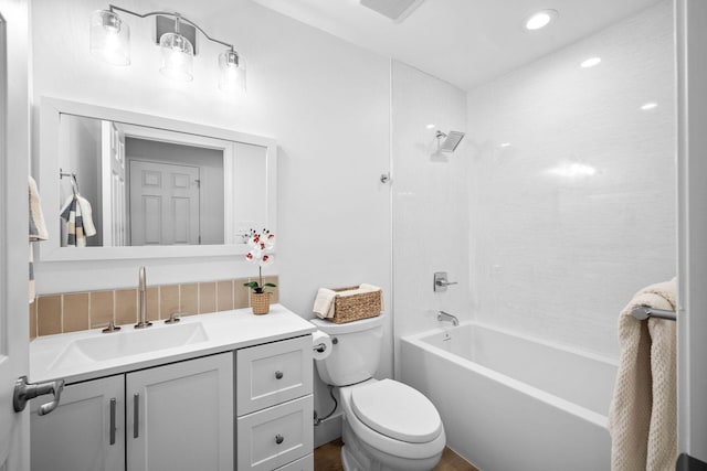 full bathroom featuring washtub / shower combination, vanity, and toilet