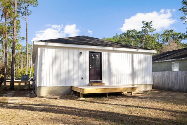 rear view of property featuring a yard and central air condition unit