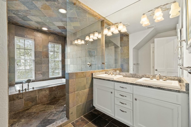 bathroom featuring vanity, tile walls, and tiled tub