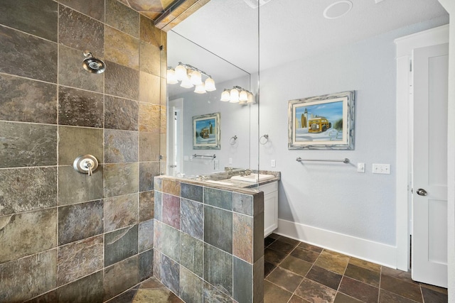 bathroom featuring vanity and a tile shower