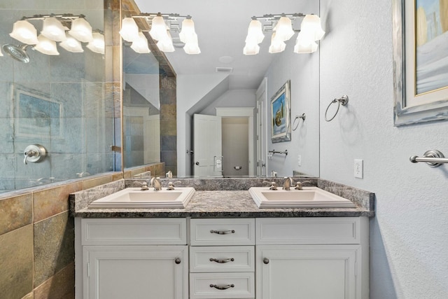 bathroom with vanity and a tile shower