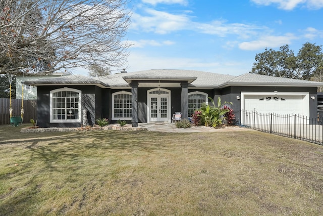 ranch-style house with a garage, a front lawn, and french doors