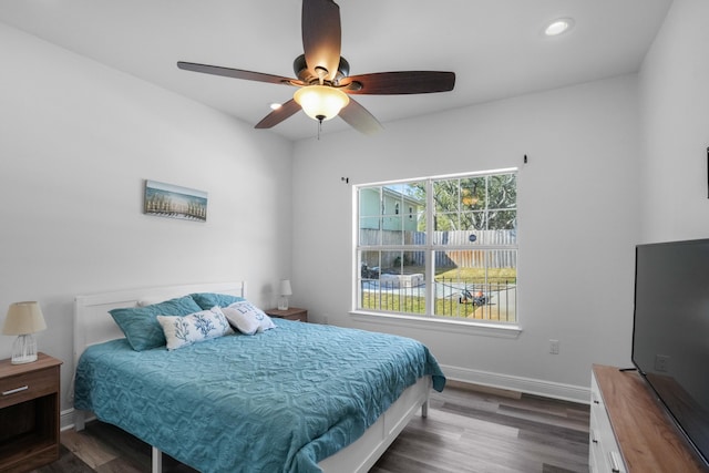 bedroom featuring ceiling fan and dark hardwood / wood-style floors