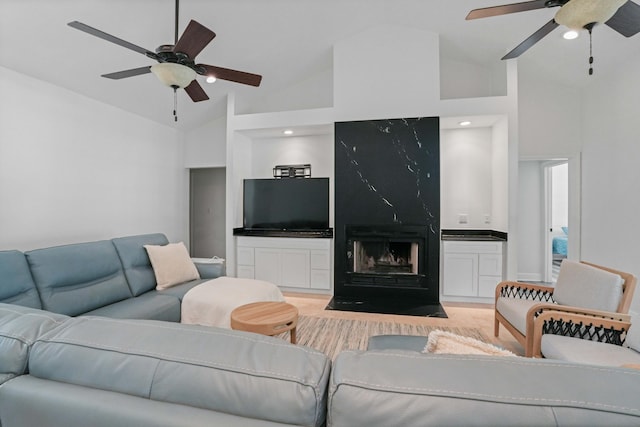 living room featuring high vaulted ceiling and ceiling fan