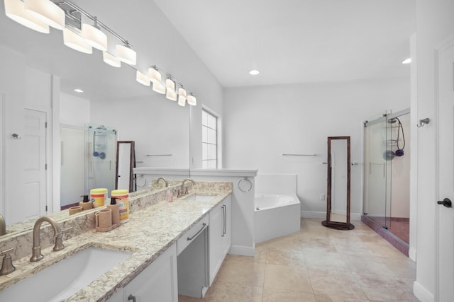 bathroom featuring plus walk in shower, vanity, and tile patterned floors