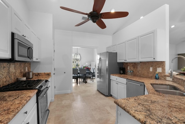 kitchen featuring sink, light tile patterned floors, appliances with stainless steel finishes, decorative backsplash, and white cabinets