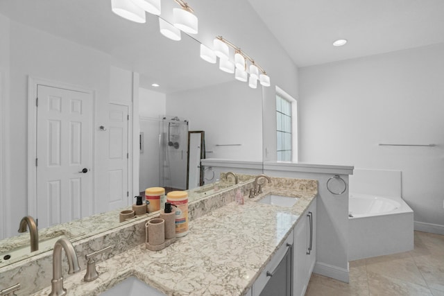 bathroom featuring tile patterned flooring, shower with separate bathtub, and vanity