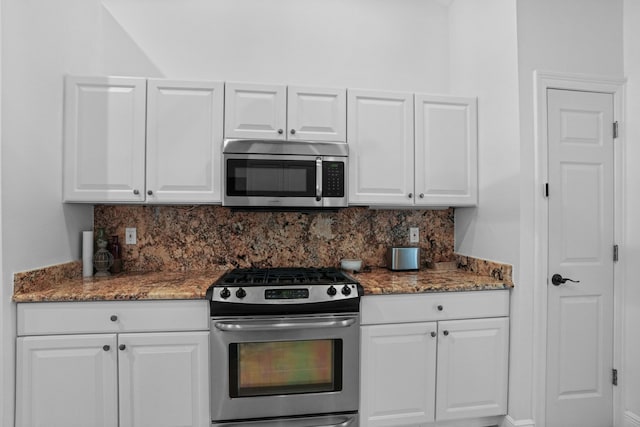 kitchen featuring appliances with stainless steel finishes, decorative backsplash, and white cabinets