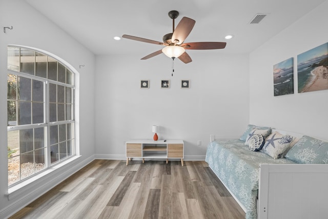 bedroom featuring hardwood / wood-style flooring and ceiling fan