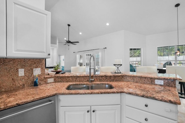 kitchen featuring hanging light fixtures, dishwasher, sink, and white cabinets