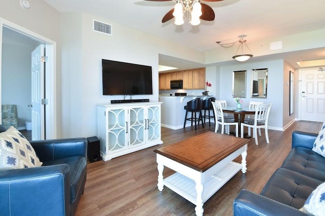 living room featuring hardwood / wood-style flooring and ceiling fan