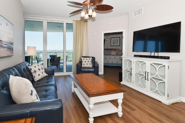 living room featuring dark hardwood / wood-style floors and ceiling fan