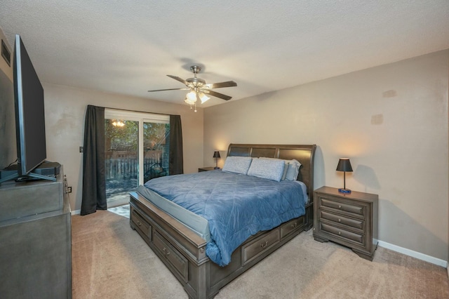 bedroom featuring ceiling fan, light colored carpet, a textured ceiling, and access to outside