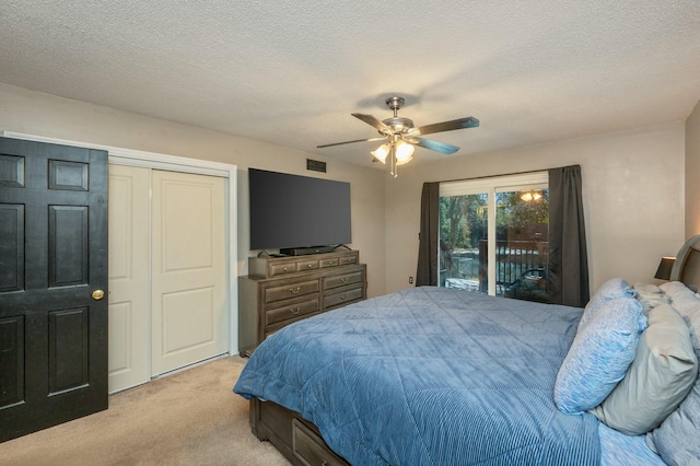 carpeted bedroom featuring ceiling fan, access to outside, a textured ceiling, and a closet