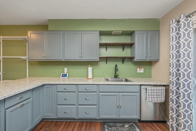 kitchen featuring sink, gray cabinets, stainless steel dishwasher, and dark hardwood / wood-style floors