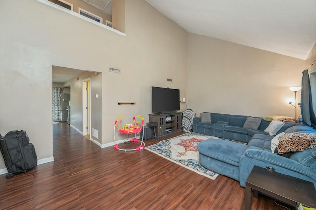 living room with dark hardwood / wood-style floors and high vaulted ceiling