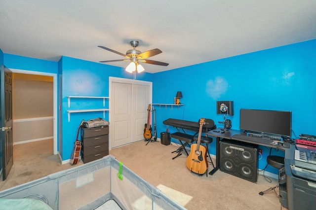 home office featuring light colored carpet and ceiling fan