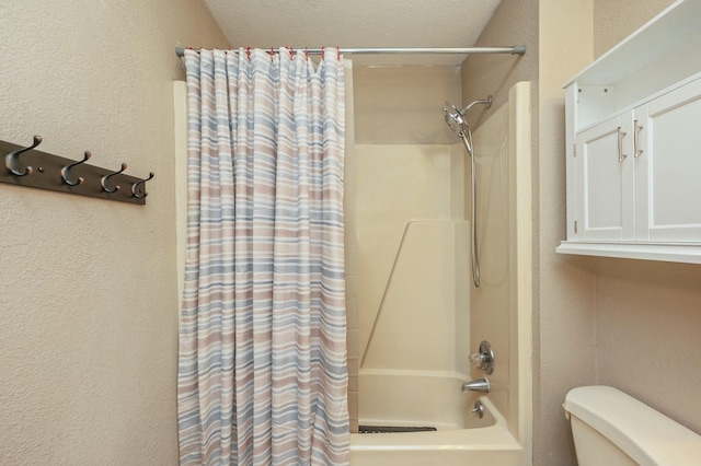 bathroom featuring shower / tub combo with curtain and toilet