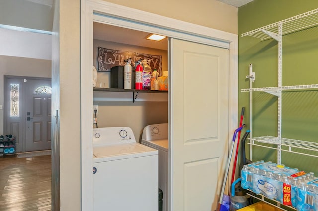 clothes washing area with separate washer and dryer and hardwood / wood-style floors