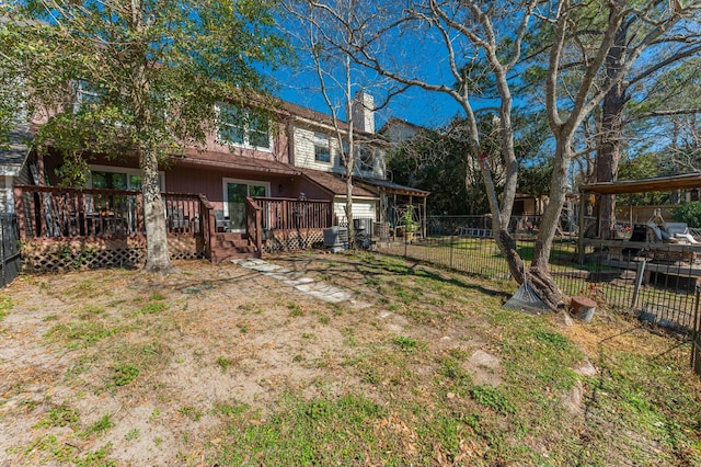 view of yard featuring a wooden deck and a carport