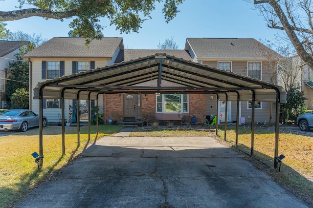 view of front facade with a front yard and a carport