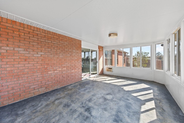 unfurnished sunroom featuring a wall unit AC