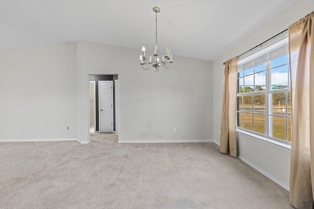 carpeted spare room with lofted ceiling and an inviting chandelier