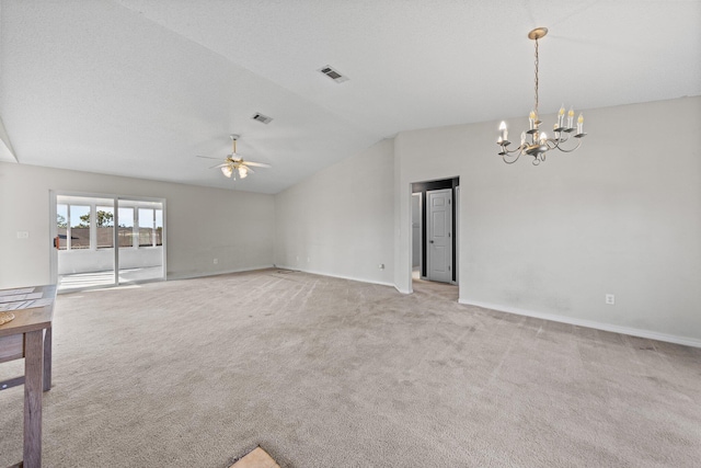 spare room featuring light carpet, ceiling fan with notable chandelier, and lofted ceiling