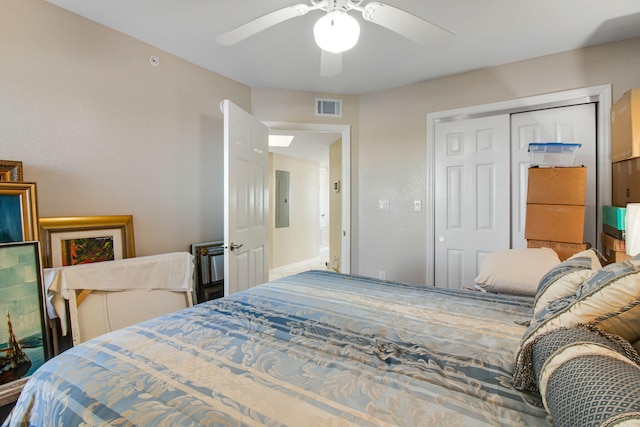 bedroom with electric panel, ceiling fan, and a closet