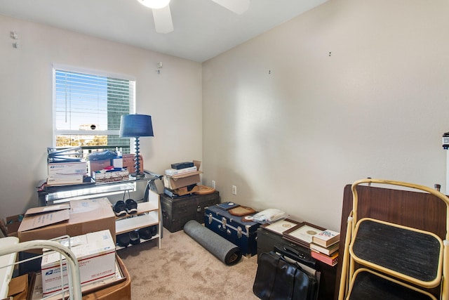 home office featuring light carpet and ceiling fan