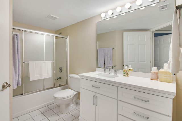 full bathroom with tile patterned flooring, bath / shower combo with glass door, vanity, and toilet