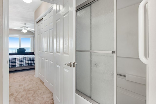 hallway featuring light colored carpet