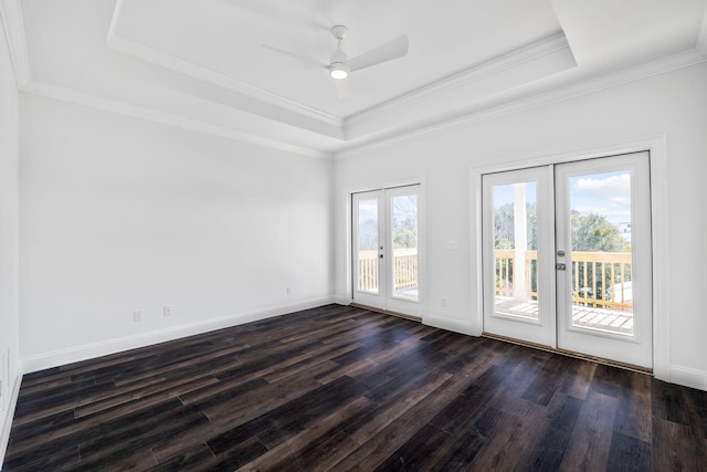 unfurnished room featuring french doors, ornamental molding, dark hardwood / wood-style floors, a raised ceiling, and ceiling fan