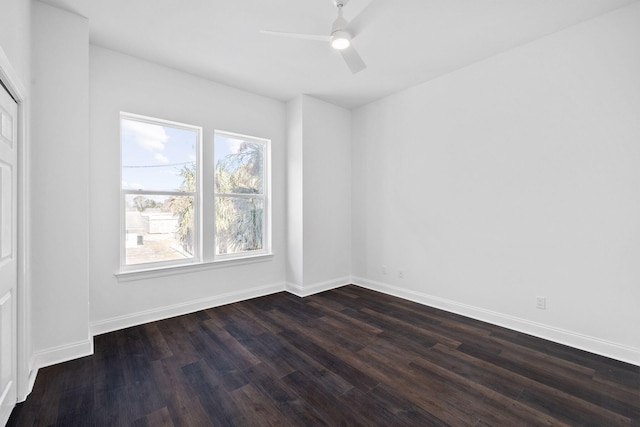 empty room with dark wood-type flooring and ceiling fan