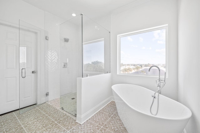 bathroom featuring tile patterned floors and separate shower and tub